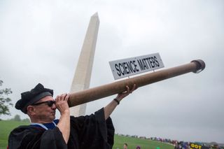 A science supporter dressed as Galileo (complete with telescope) is seen near the Washington Monument during the March for Science in Washington D.C. on April 22, 2017.