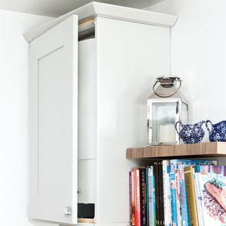 room with white wall and open book shelve
