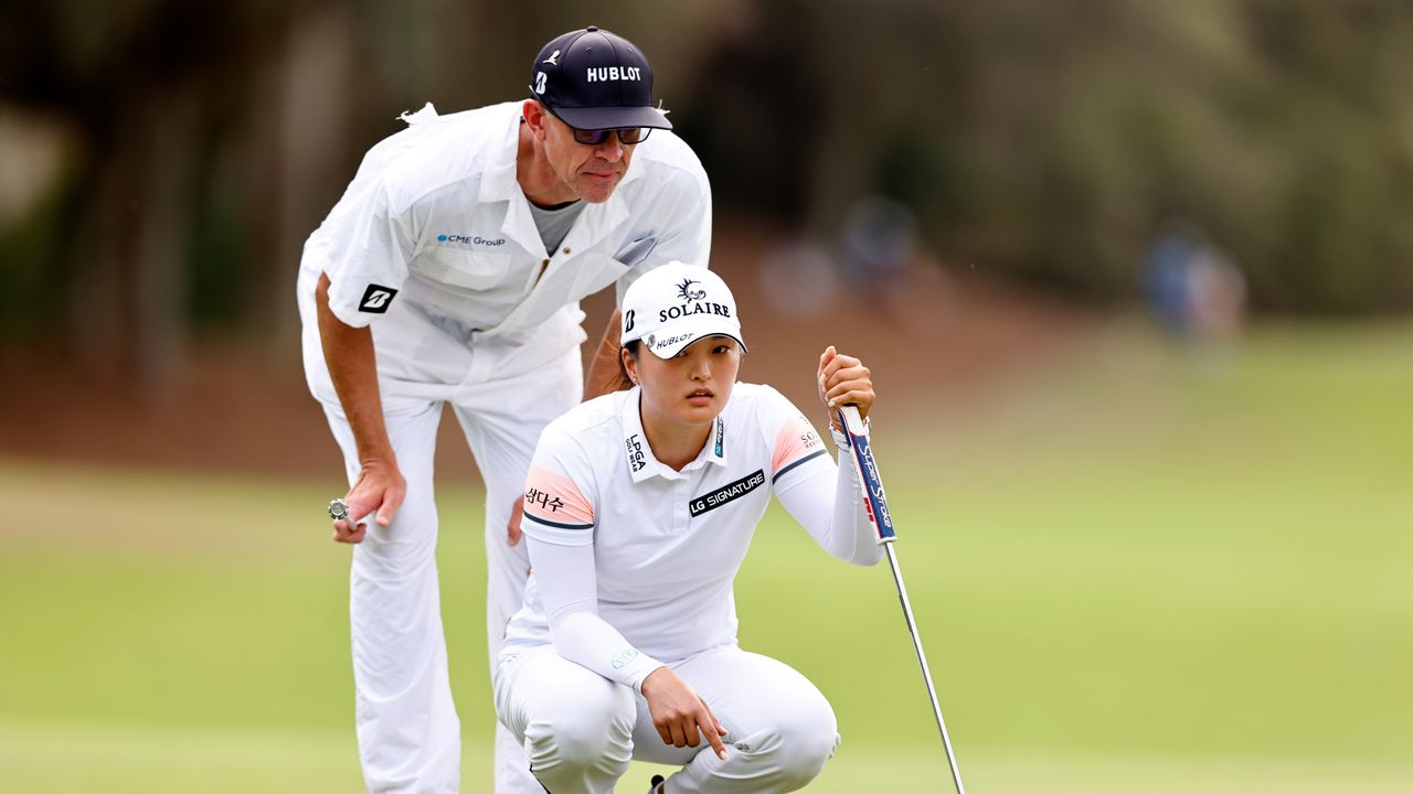 Jin-young Ko of South Korea and caddie David Brooker lines up a putt on the third green during the final round of the CME Group Tour Championship at Tiburon Golf Club on November 21, 2021 in Naples, Florida.