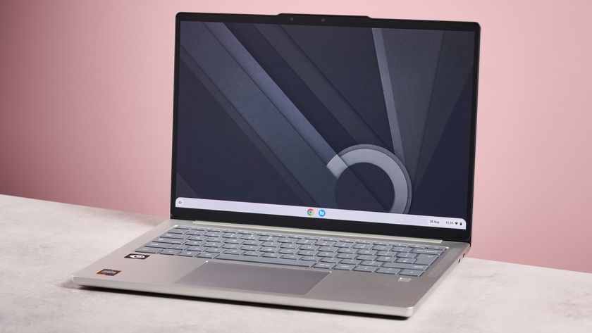 Lenovo Chromebook Plus 14-inch open on desk with pink background