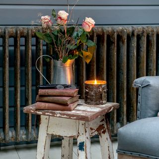 wooden table with rose flower and books