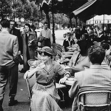 Monochrome, Hat, Photograph, Mammal, Style, Black-and-white, Chair, Monochrome photography, Crowd, Sun hat, 