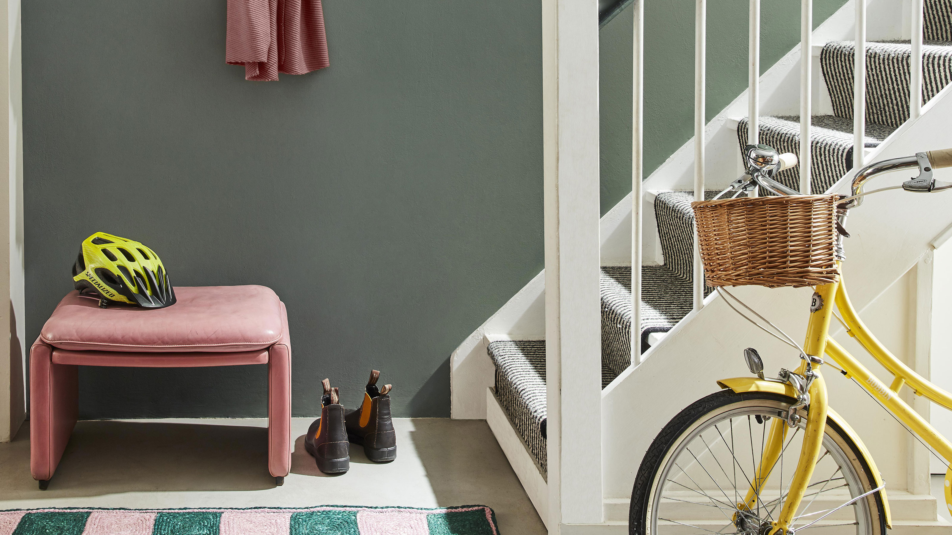 green hallway and stairs with wall painted in green from Little Greene's Re:Mix collection