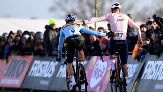 Wout van Aert congratulating Mathieu van der Poel after crossing the line at cyclocross world championships