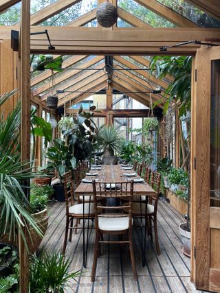 Sunroom used as dining room filled with plants
