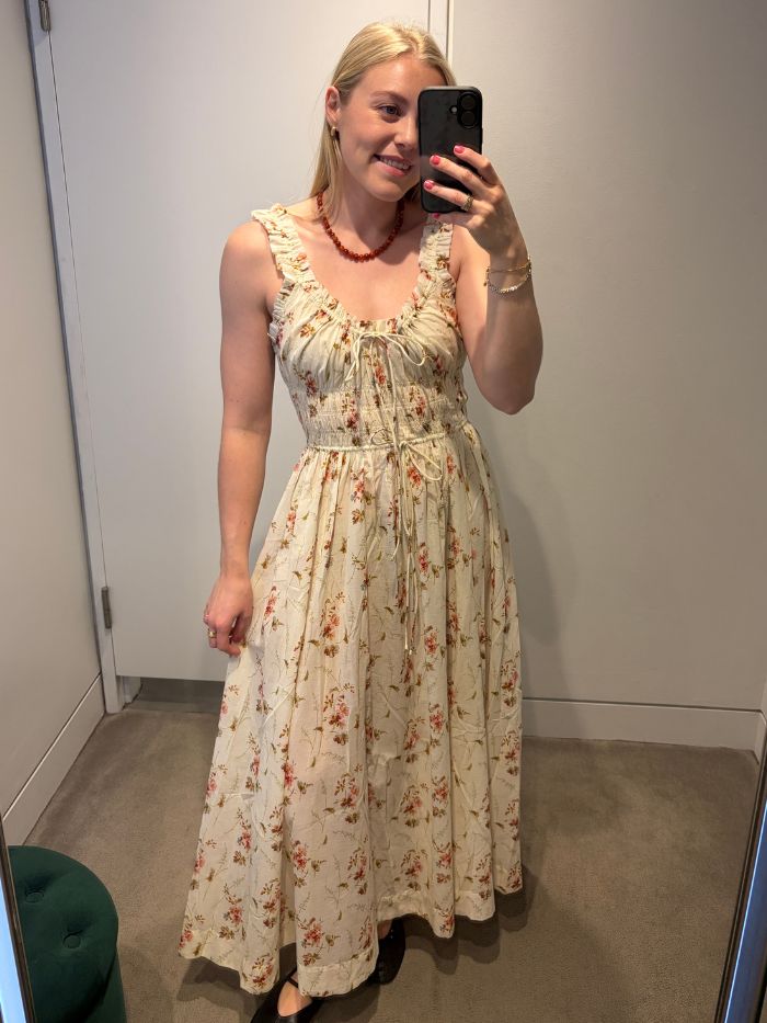 Woman wears floral Doen dress with black ballet flats