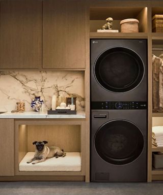 A stacked laundry set in an artificialy lit laundry room