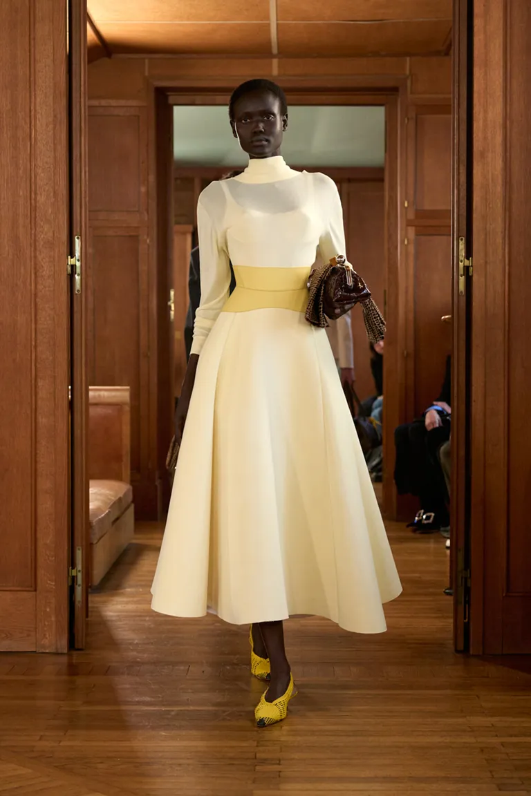 Jacquemus model wearing a yellow maxi dress.