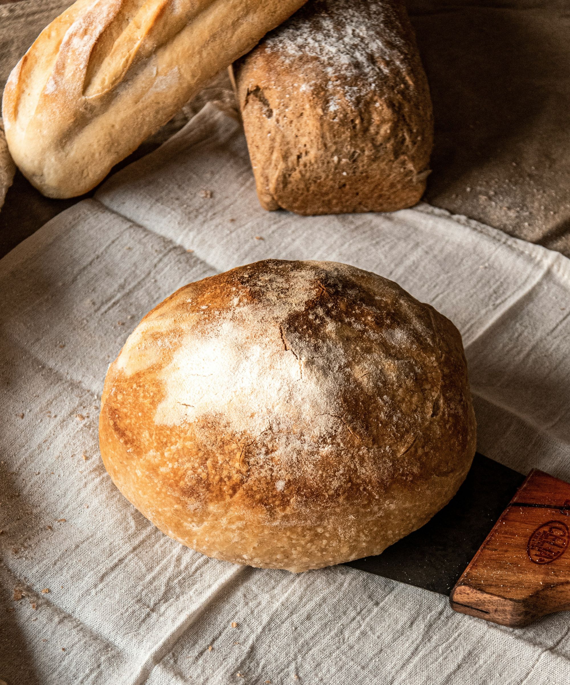 Loaves of bread on a linen table cloth