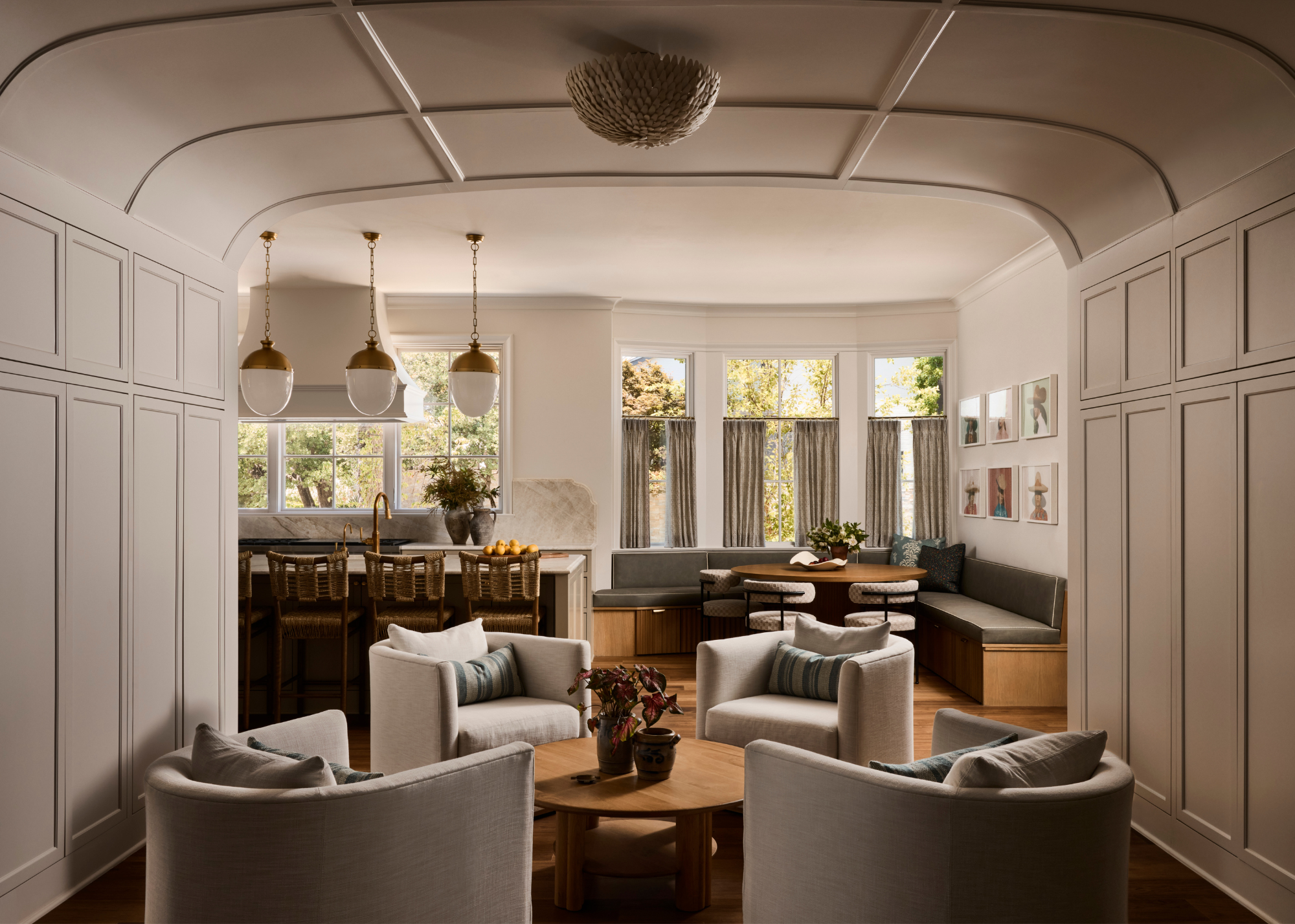 vaulted living room with wall panelling, leading into an open plan kitchen with built-in dining area