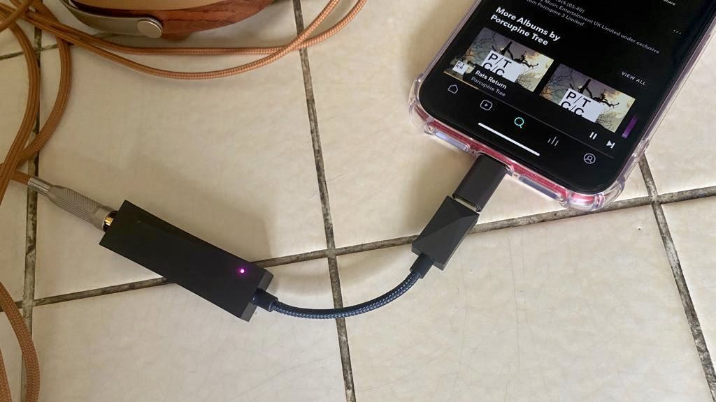 Astell &amp; Kern HC3 on a white coffee table, connected to an iPhone XR