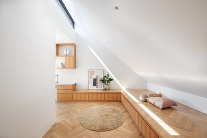 A white walled room with wooden floor