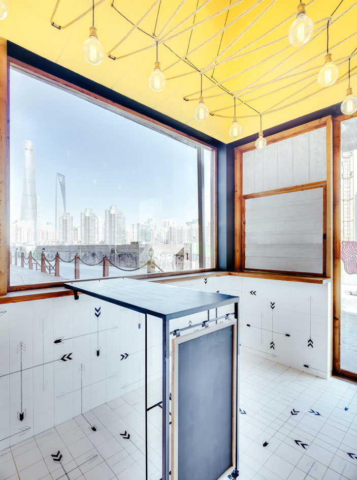 Predominantly in timber with custom-printed tiles, that wrap around the counters and floors, featuring an arrowhead motif