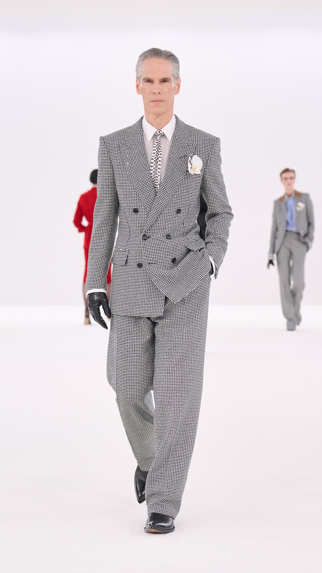 a Tom Ford model wearing a houndstooth suit on the runway