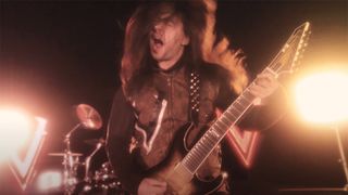 Luis Kalil playing guitar with Red Devil Vortex in the More Luck Than Brains music video