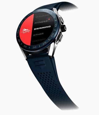 Tag sports watch with blue rubber strap and red and black face.