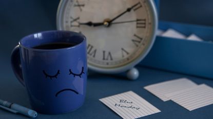 Blue cup with a sad face, and card reading 'Blue Monday'