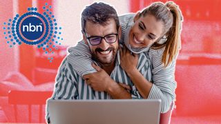 Couple looking happy whilst using a laptop. The NBN Co logo is in the top left