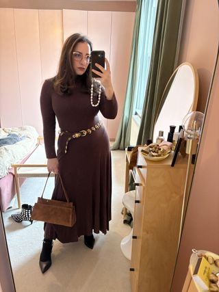 woman wearing a brown dress and studded belt