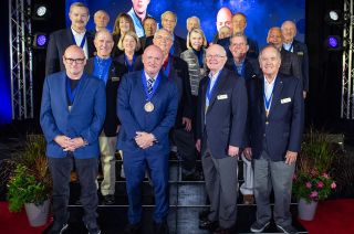 2023 U.S. Astronaut Hall of Fame inductees Roy Bridges (at center right) and Senator Mark Kelly (center left) pose with prior inductees during their ceremony at Kennedy Space Center Visitor Complex in Florida on Saturday May 6, 2023. The other astronauts pictured include (from left to right): Scott Kelly, Scott Altman, Curt Brown, John Grunsfeld, Janet Kavandi, Pam Melroy, Michael Lopez-Alegria, Daniel Brandenstein, John Blaha, Rhea Seddon, Rusty Schweickart, Joe Kerwin, Hoot Gibson, David Leestma, Bob Crippen, Charlie Bolden and Loren Shriver.