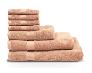 The Linen Yard Loft Combed Cotton Bath Towel in pink, stacked on top of one another