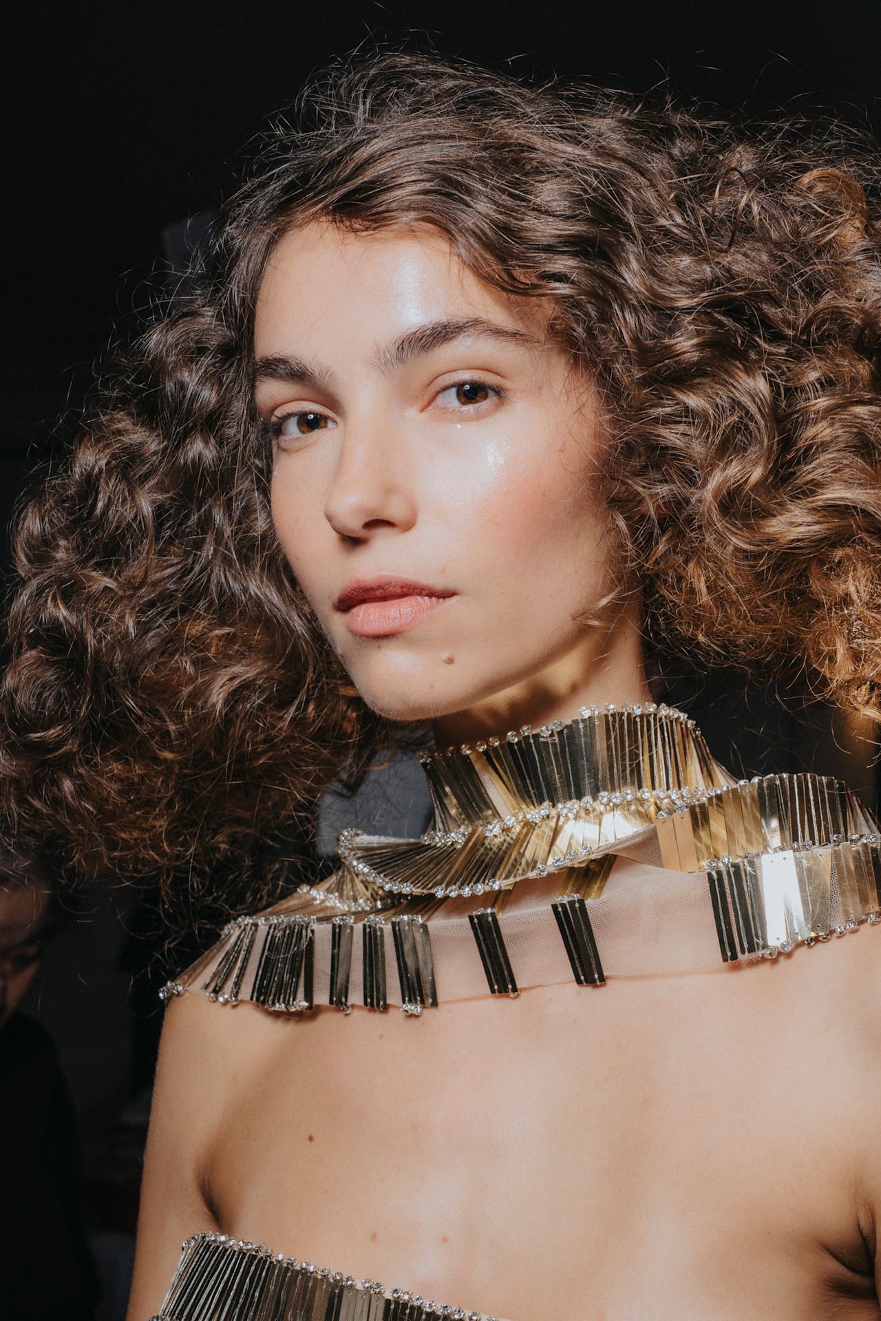 Blush heavy with no mascara at Nardos on a pretty model with gold around her neck.