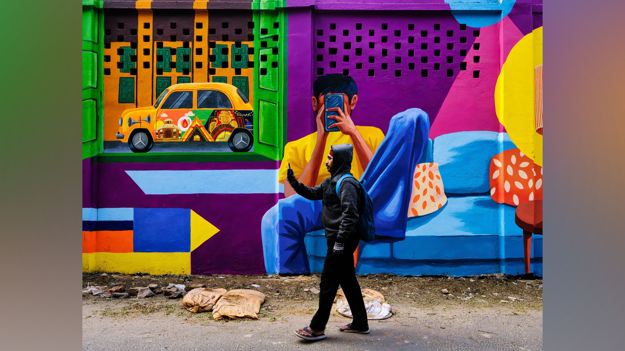 Art collides with the real world in this split-second, award-winning street photograph