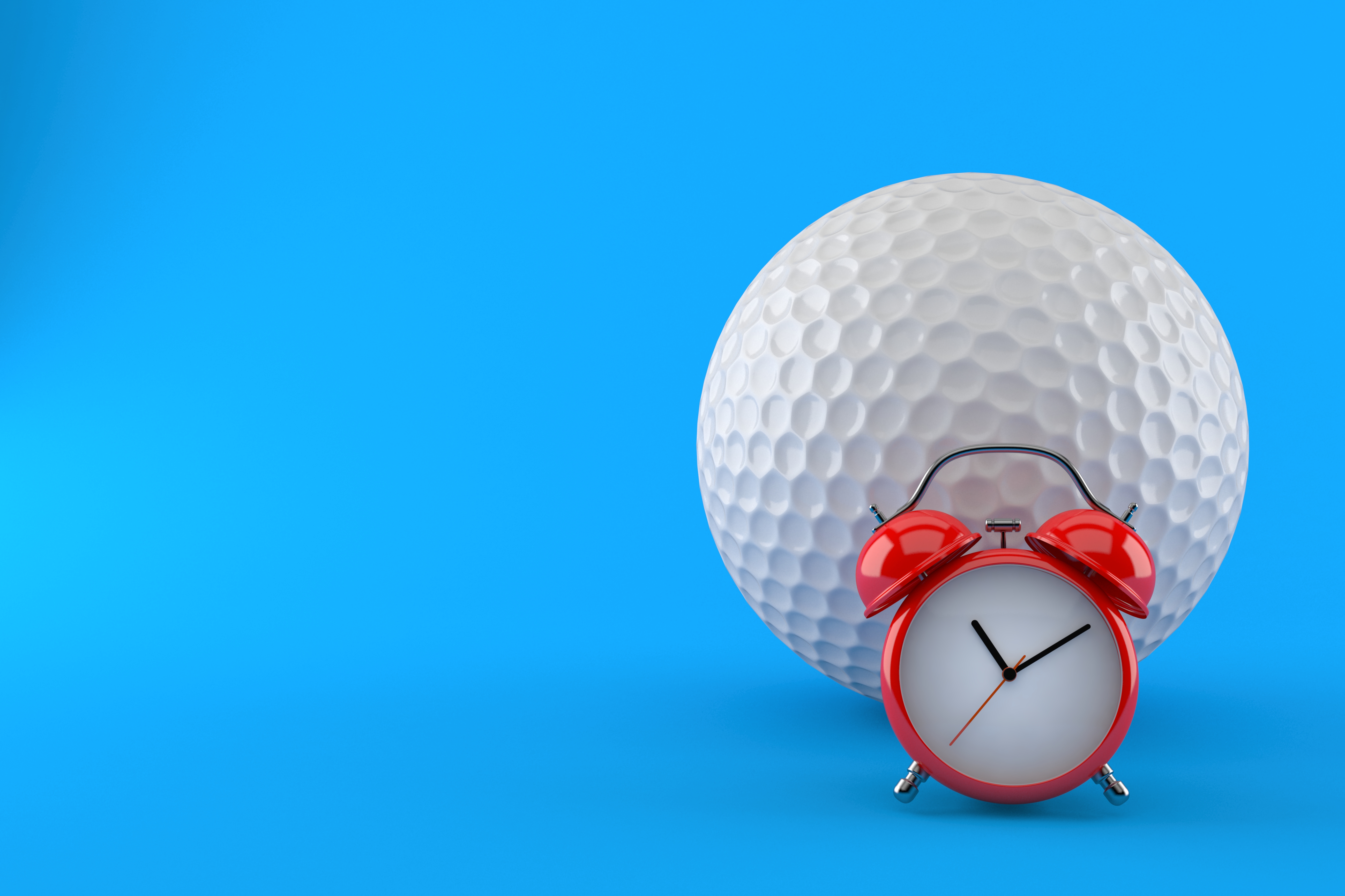 An alarm clock and a golf ball