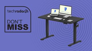A FlexiSpot EN1 standing desk on a purple background next to a TechRadar badge that reads 'Don't Miss'
