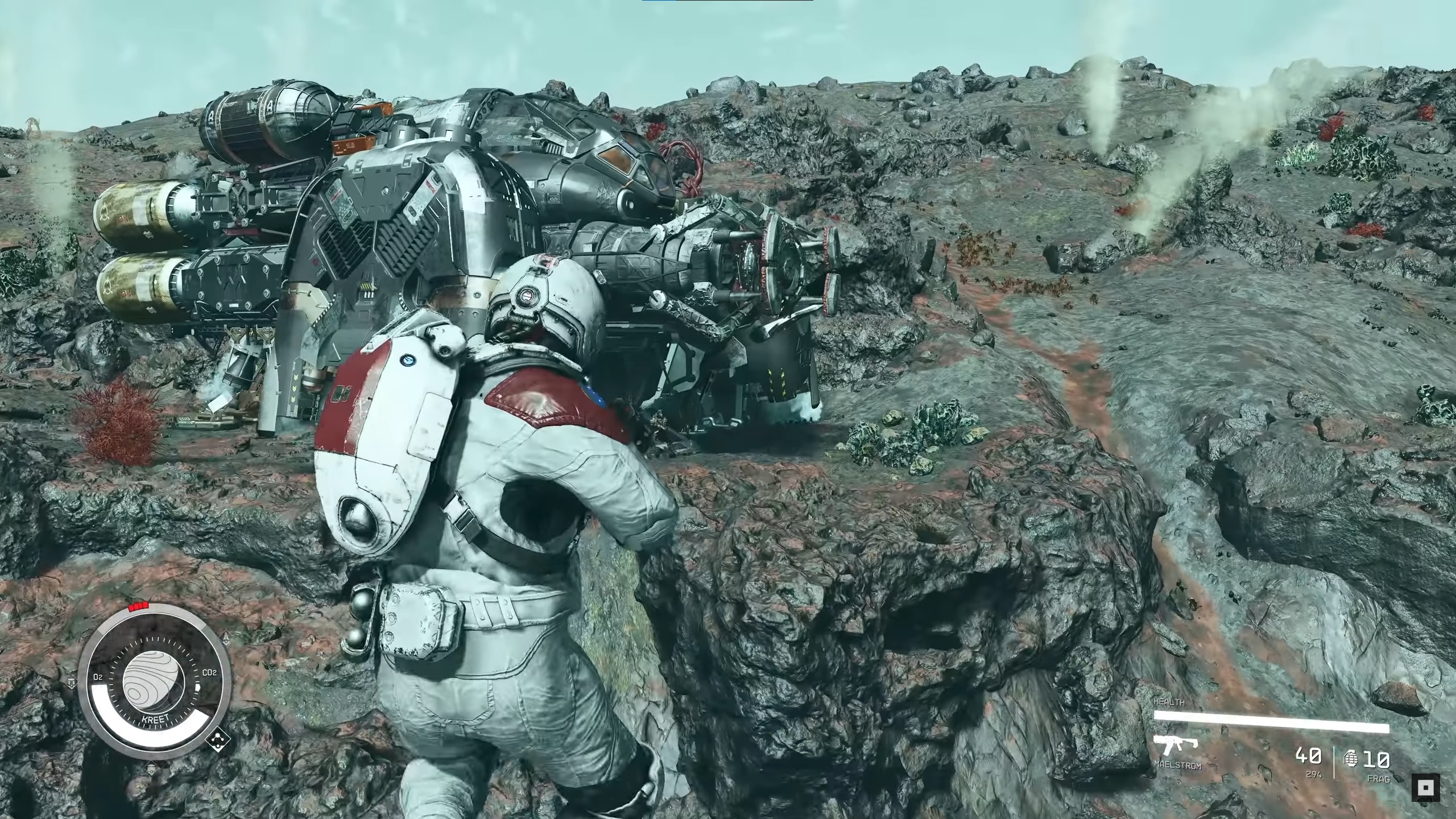 Starfield - A player in a white space suit jumps in the air holding a gun pointing at a Crimson Fleet space ship, a clunky machine with grey parts and gold plated thrusters on back.