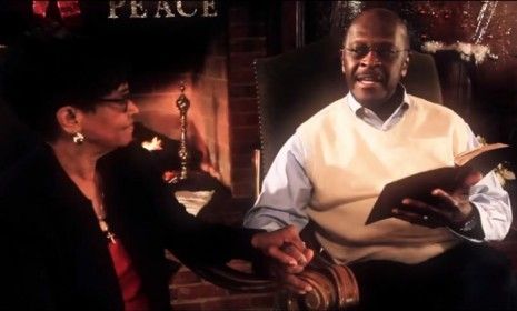 Herman Cain&amp;#039;s new Christmas video features the former presidential hopeful reading from the Bible while holding hands with his wife, Gloria.