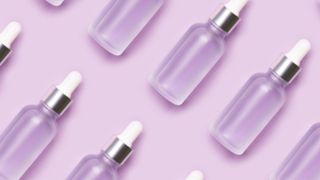 Image of retinol oil bottles with a purple background