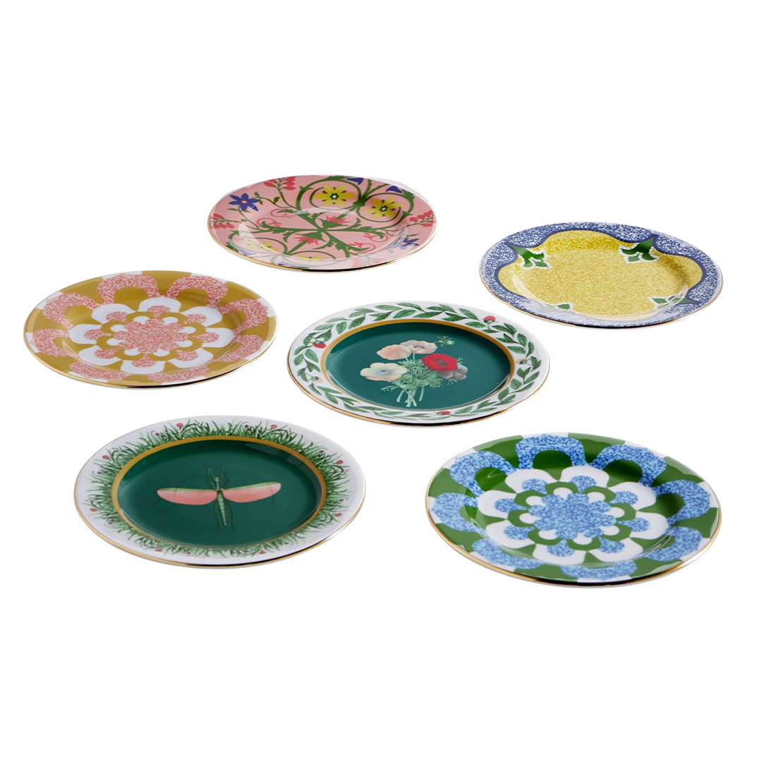 Set of six gold-plated dessert plates in varying colors and patterns