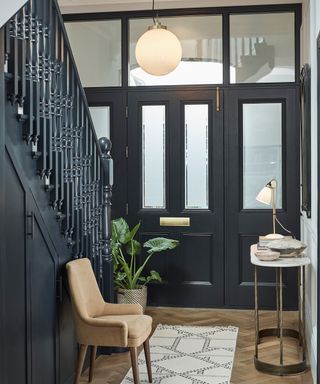 Dark navy hallway with Original BTC pendant and table lamp