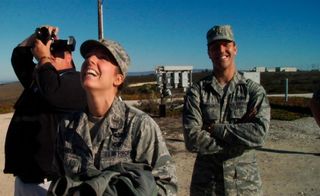 Kaylee Ausbun, the Air Force officer in charge of public affairs for this launch, smiles with relief as SpaceX's improved Falcon 9 rocket departs the launch pad on Sunday. To her left is Jim Spellman of the Western Spaceport chapter of the National Space Society.