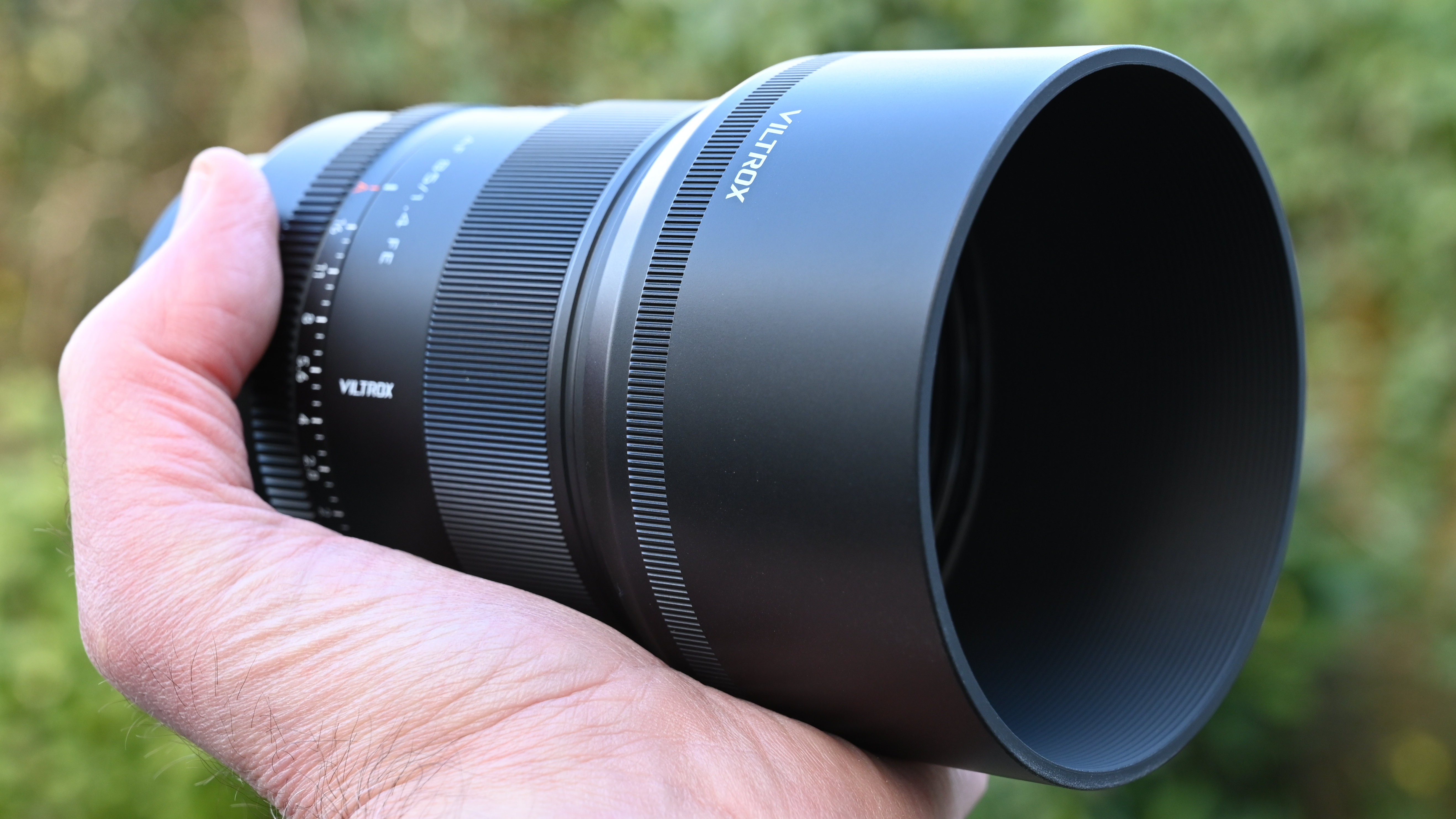 Viltrox AF 85mm f/1.4 Pro product shot, lens in hand
