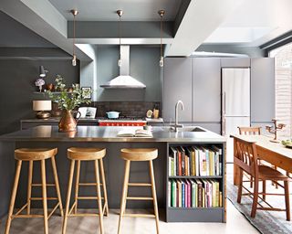 Open-plan kitchen with bar stools and books