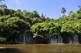 This photo depicts a waterfall on the Juma River near the town of Apui, in Amazonas State. Sweating from the hike to reach it, Walker swam across the pool at its base, only to worry halfway to the other side about possible anacondas lurking in the depths.