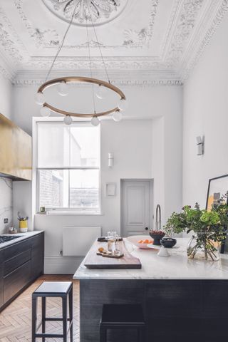 Kitchen with high ceiling and long chandelier