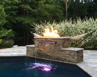 pool lighting idea with fire element combined with LED lighting