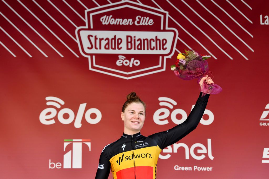 SIENA ITALY MARCH 05 Lotte Kopecky of Belgium and Team SD Worx celebrates winning the race on the podium ceremony after the Eroica 8th Strade Bianche 2022 Womens Elite a 136km one day race from Siena to Siena Piazza del Campo 321m StradeBianche on March 05 2022 in Siena Italy Photo by Luc ClaessenGetty Images