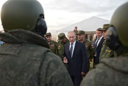 Vladimir Putin meets with military men.