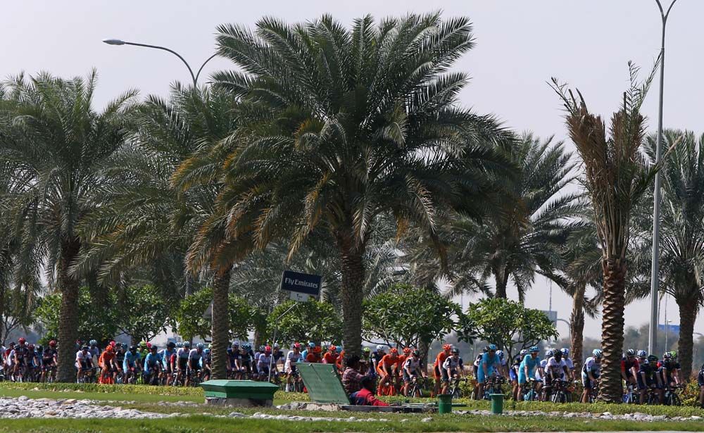 A fan cheers the riders on