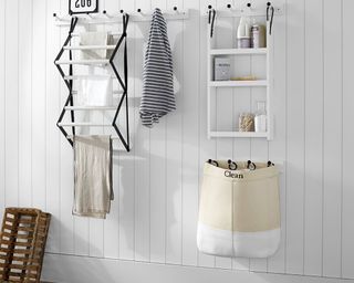 A laundry room with shiplap wall decor and assortment of laundry room organization products