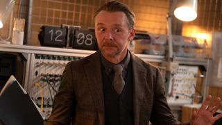 Simon Pegg stands in front of a workstation, gesturing in frustration in Mission: Impossible - The Final Reckoning.