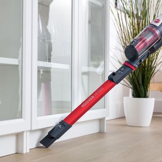 Hoover HF500 Cordless Vacuum cleaning under cupboard door