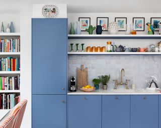 One-wall kitchen with blue cabinets, open shelving and tiled backsplash