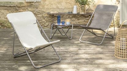 Two deckchairs in an outdoor space with wooden decking