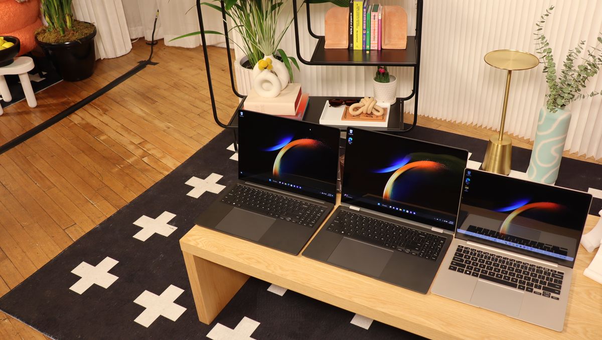 Three Samsung Galaxy Book3 sat next to each other on a wooden table