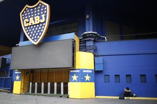 A football fan mourns Diego Maradona outside La Bombomera, home of Boca Juniors